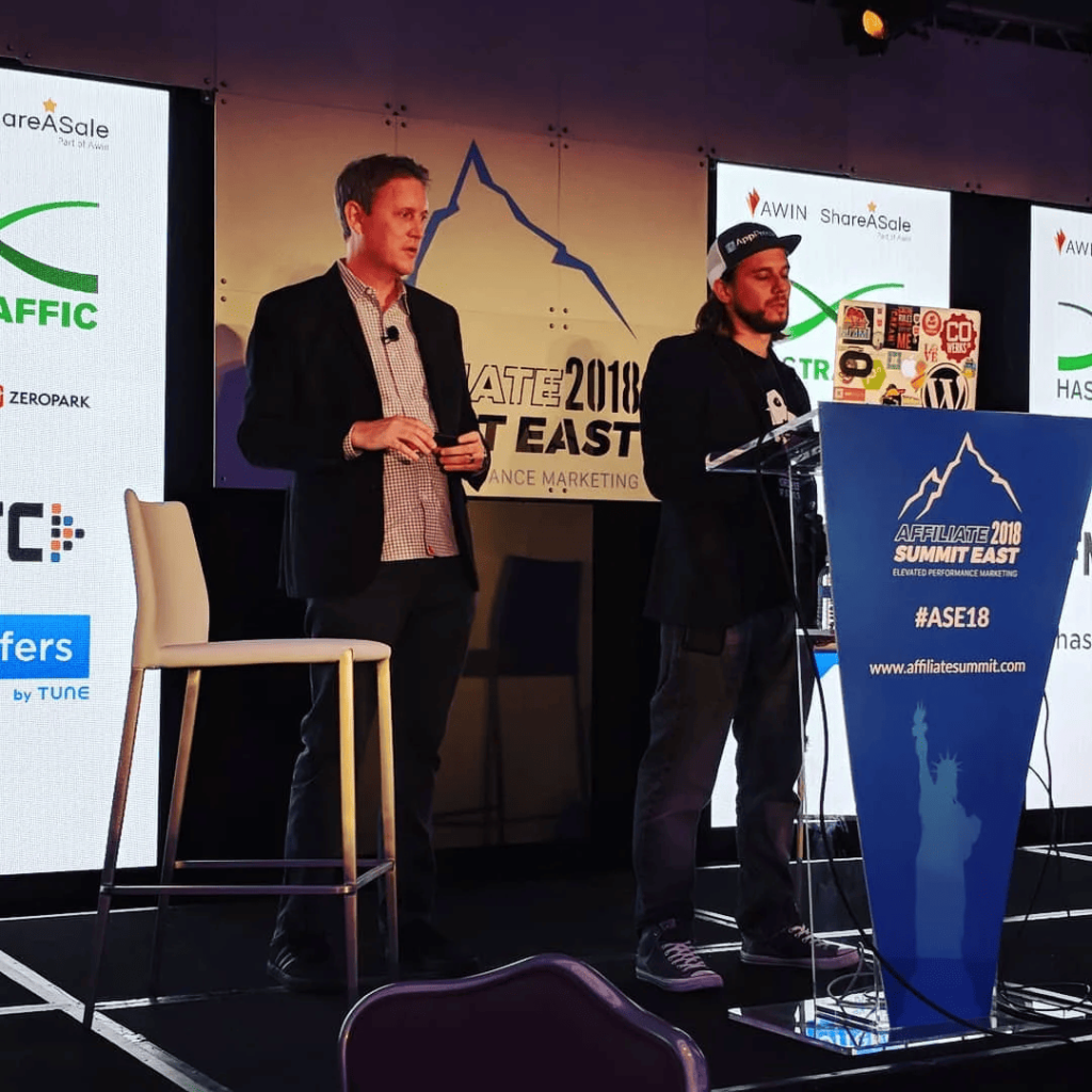 Brian Messenlehner at the podium and David Vogelpohl beside him during the Affiliate Summit East 2018 closing keynote