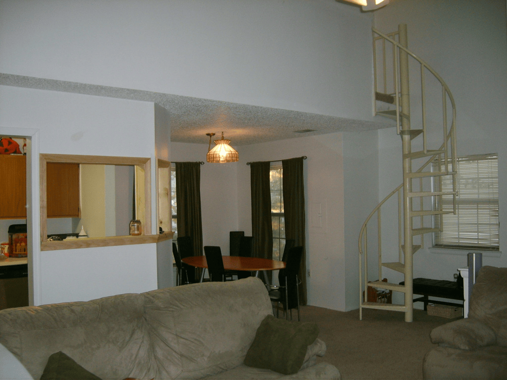 The condo dining area and a spiral staircase leading up to the loft