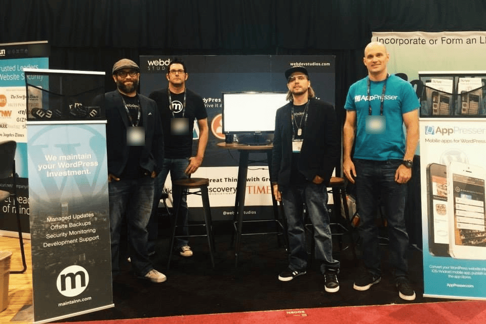 Brian Messenlehner and three others at a WebDevStudios expo booth next to an AppPresser mobile apps for WordPress banner