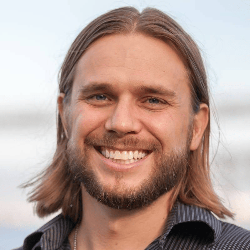 Portrait of Brian Messenlehner, founder of AlphaWeb, smiling outdoors