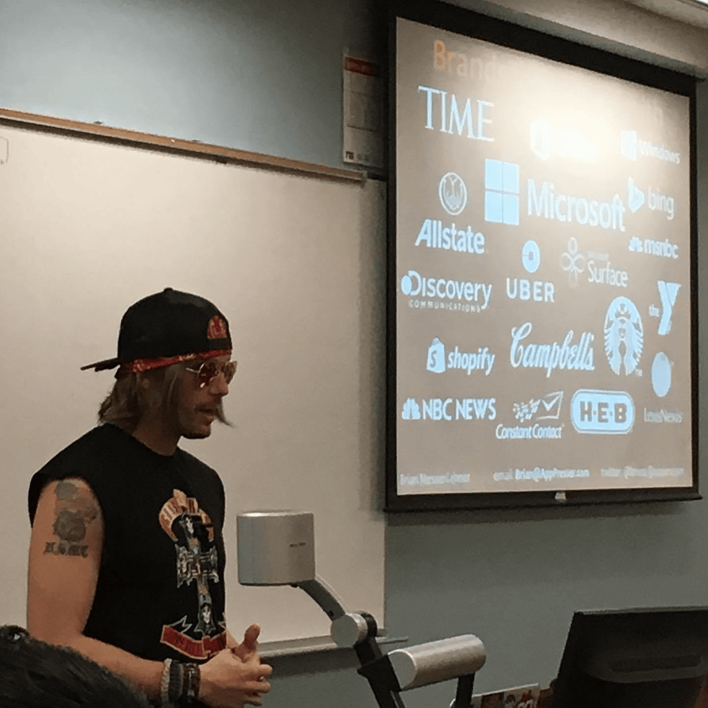 Brian Messenlehner giving a WordPress talk in front of a slide of brand logos