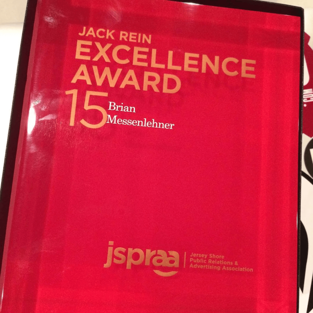 Red glass Jack Rein Excellence Award plaque from JSPRAA engraved with Brian Messenlehner