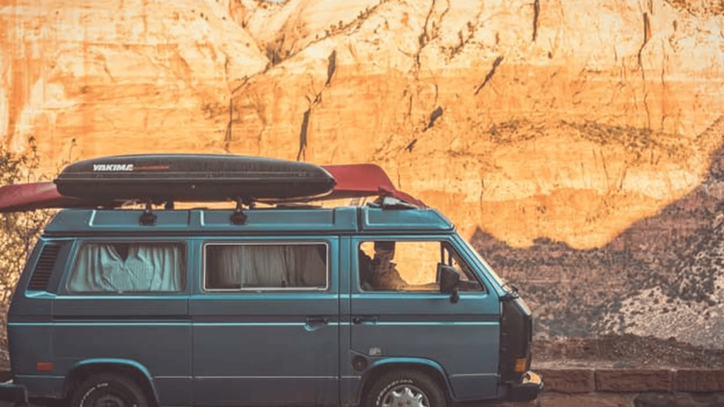 Van parked below canyon cliffs, from the portal design