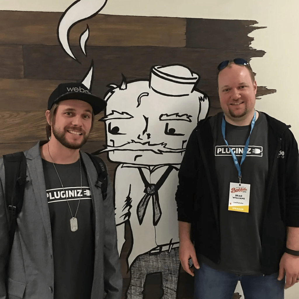 Brian Messenlehner and Brad Williams in Pluginize shirts at WordCamp Buffalo 2016, Brad wearing his speaker badge
